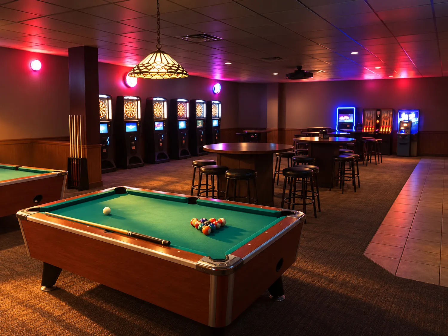 A pool table under neon in the back room